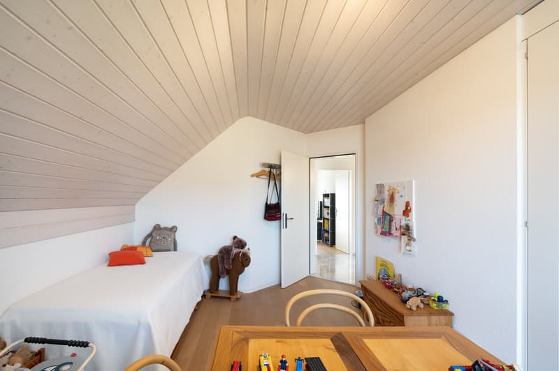 small room with bed, toys, wooden desk, wooden chair, wooden cabinet, wooden ceiling