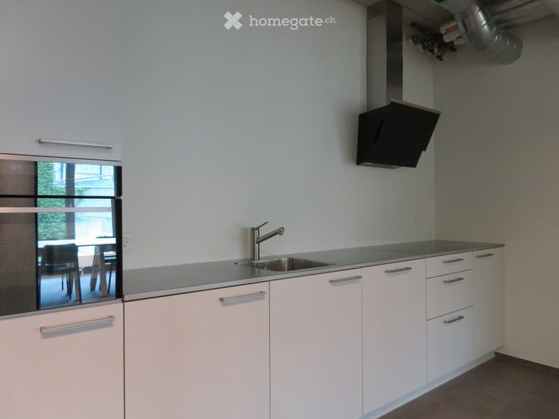 modern kitchen, white cabinets, stainless steel countertop, sink, gas stove, oven, dishwasher, extractor hood, floor lamp