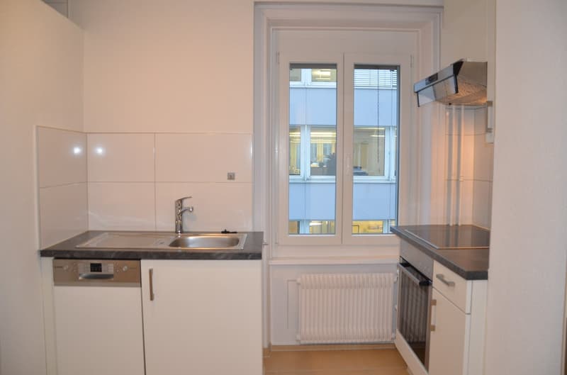 modern kitchen with white cabinets, stainless steel sink, dishwasher, gas stove, window with blinds, white tiles