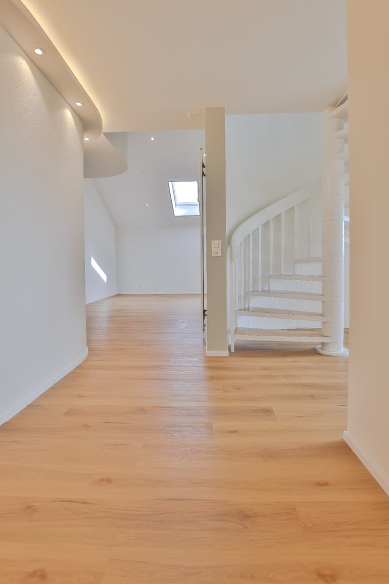 Staircase, hardwood floor, white walls