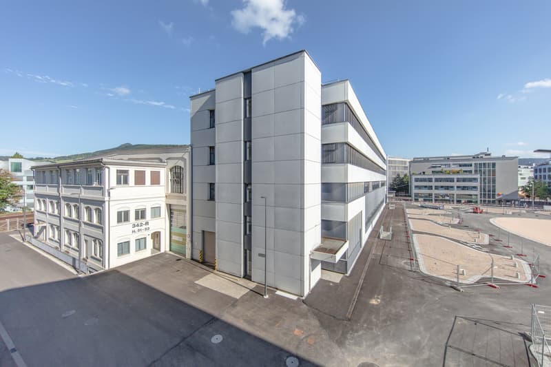 Modern architecture office building, white exterior, multiple floors, structured parking lot, multiple windows