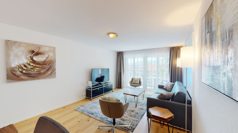Wooden floor, gray sofa, TV, coffee table, large windows, paintings