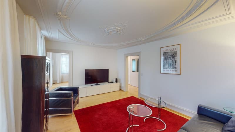 modern living room, white walls, wooden floor, red carpet, large flatscreen tv, furniture