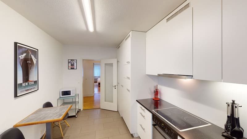 Modern kitchen with island, built-in oven and microwave, countertop, cabinets, flooring