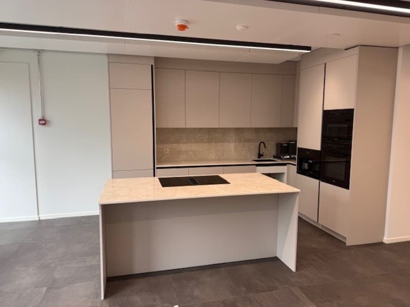 modern kitchen with white cabinets, granite countertop, black induction stove, built-in oven, dishwasher, sink, faucet, tiled floor