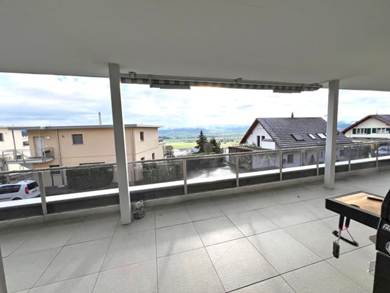 tiled balcony, railings, open space, view of surroundings, some greenery