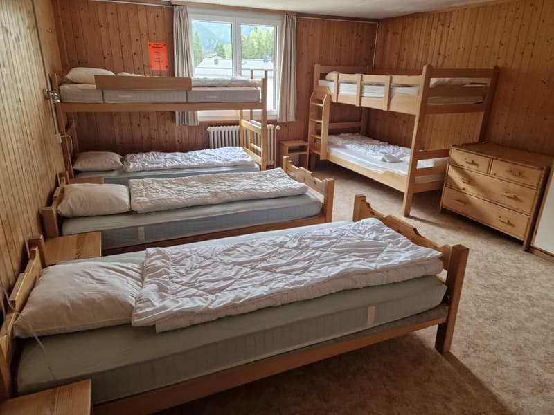 wooden walls, bunk beds, pillow, mattress, heater, wooden nightstand, drawers, wooden desk