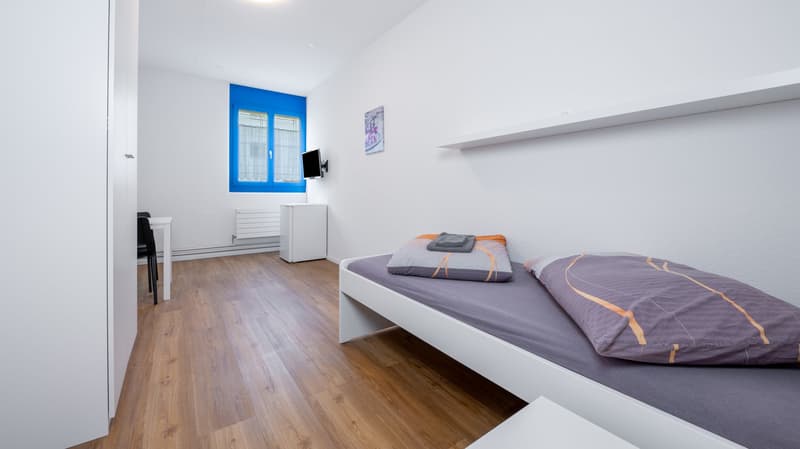 room, wooden floor, bed, desk, chair, radiator, TV, shelf, picture
