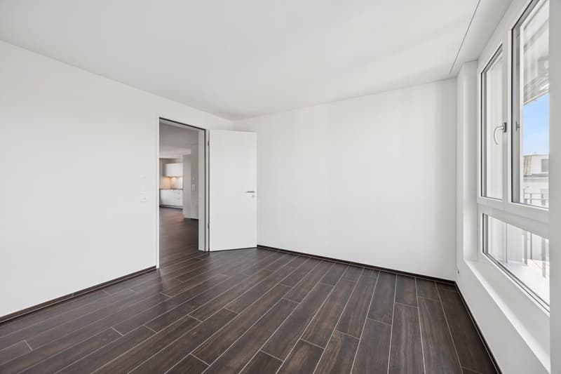 Empty room, white walls, wooden floor, large windows