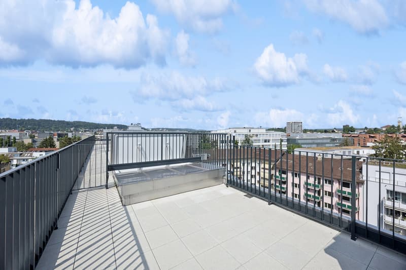 tiled terrace with metal railings, open views of cityscape