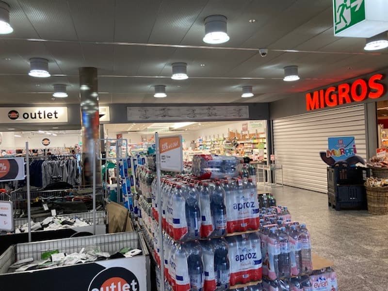 Grocery store with clothing section and various products on display