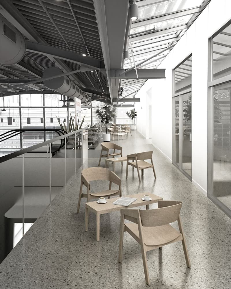 Open space with tables and chairs, glass walls, ceiling with lights, plants, and a staircase