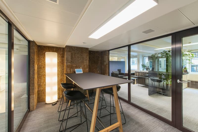 modern office with a table, wooden floor, glass walls, LED light