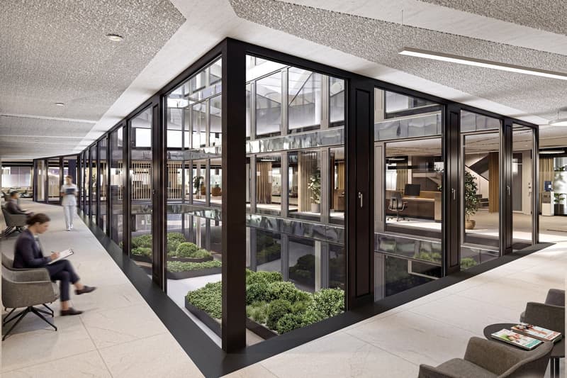 modern office with large glass walls, indoor plants, tiled floor, chairs, tables, people sitting
