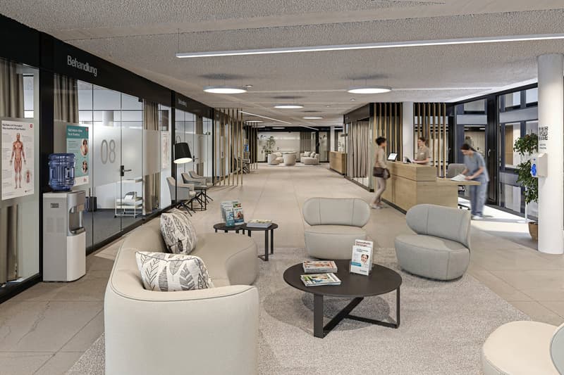 modern waiting area with couches, tables, and a reception desk