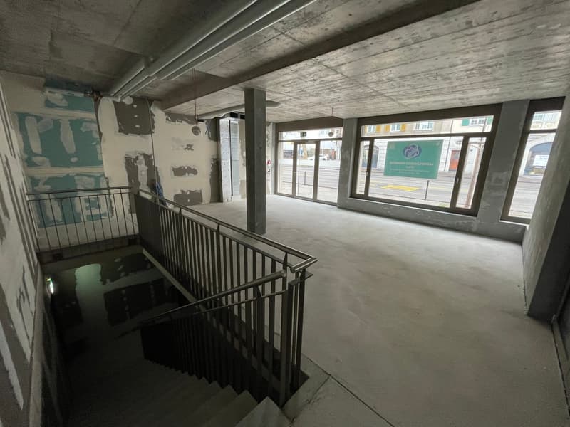 interior building with staircase, white concrete floor, unfinished wall