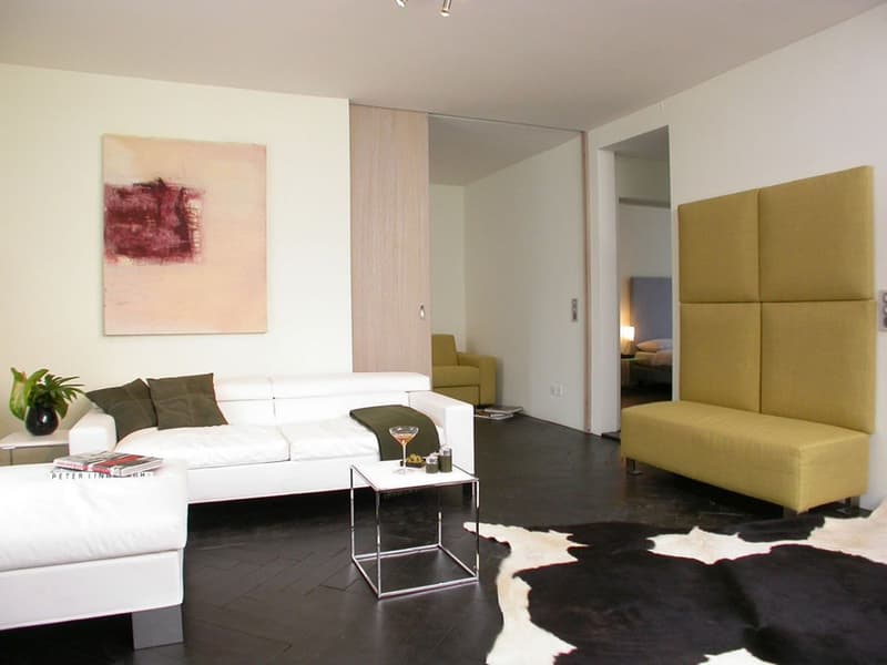 white couch, side table, decorative objects, decorative artwork, yellow couch, carpet