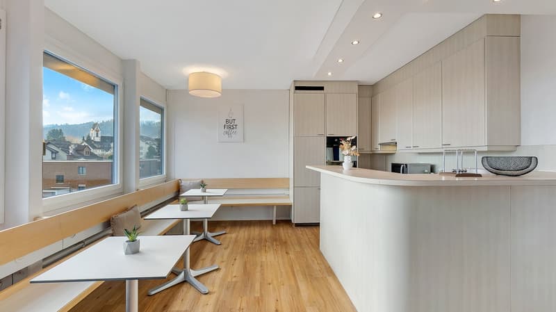 modern kitchen with wooden floor, white walls, large windows, built-in cabinets, modern appliances, dining area with benches and tables