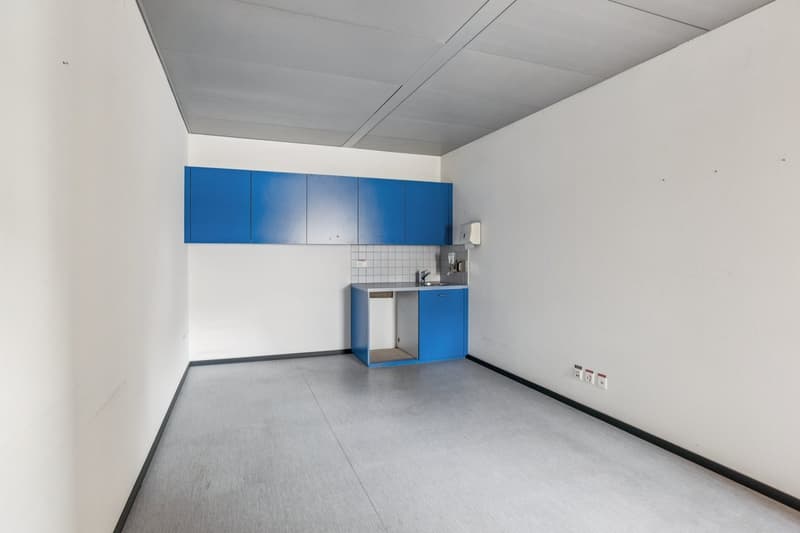 modern, empty room, blue cabinets, gray flooring, sink, electrical outlets