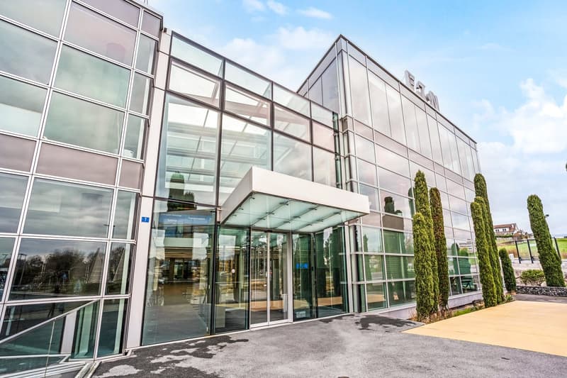 modern office building, glass facade, large entrance, glass doors, glass walls, modern design