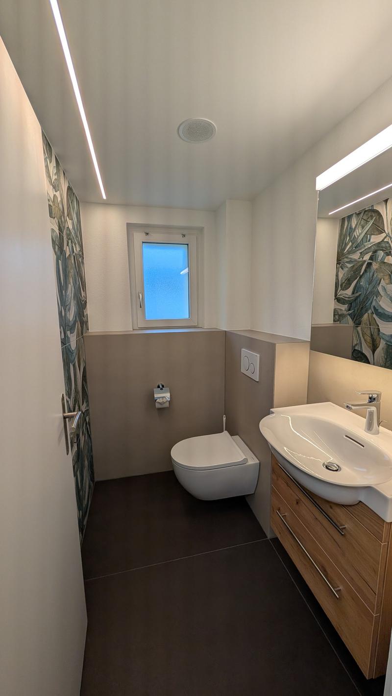 small bathroom with toilet, sink, and mirror