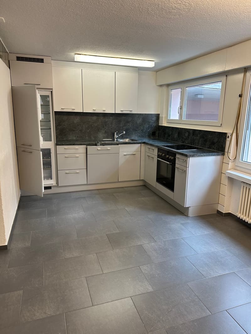 kitchen with white cabinets, granite countertops, stainless steel appliances, tile flooring, large window with daylight