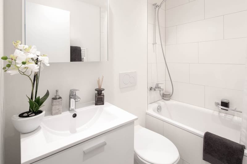 modern white bathroom, white sink, white bathtub, white toilet, shower, towel