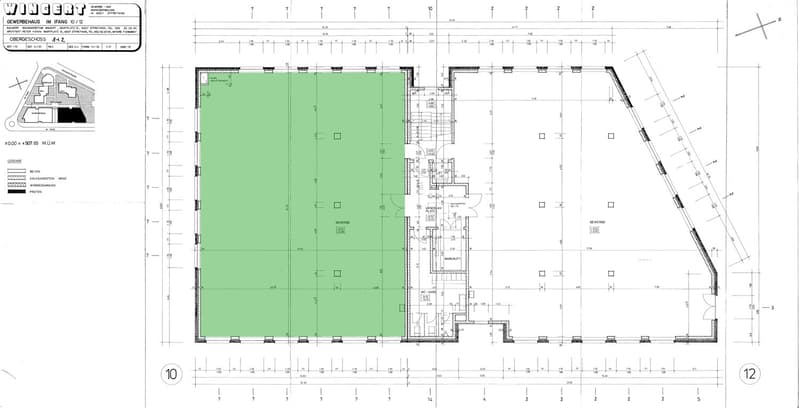 The image shows a floor plan of a commercial building. It consists of a large open space, several smaller rooms, and a parking area.