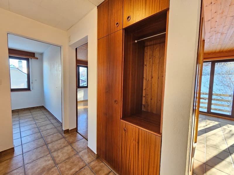 empty room, tiled floor, large wooden closet, balcony
