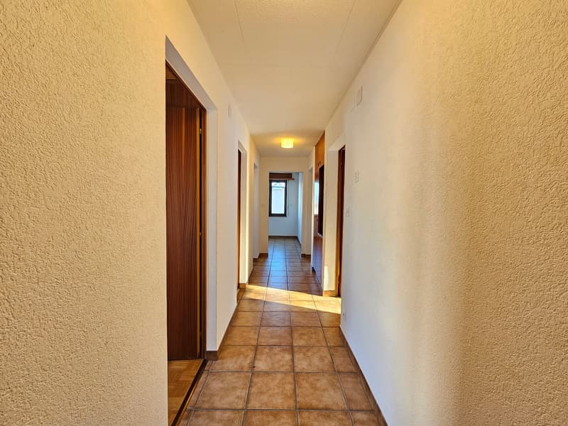 empty hallway with tiled floor and doors