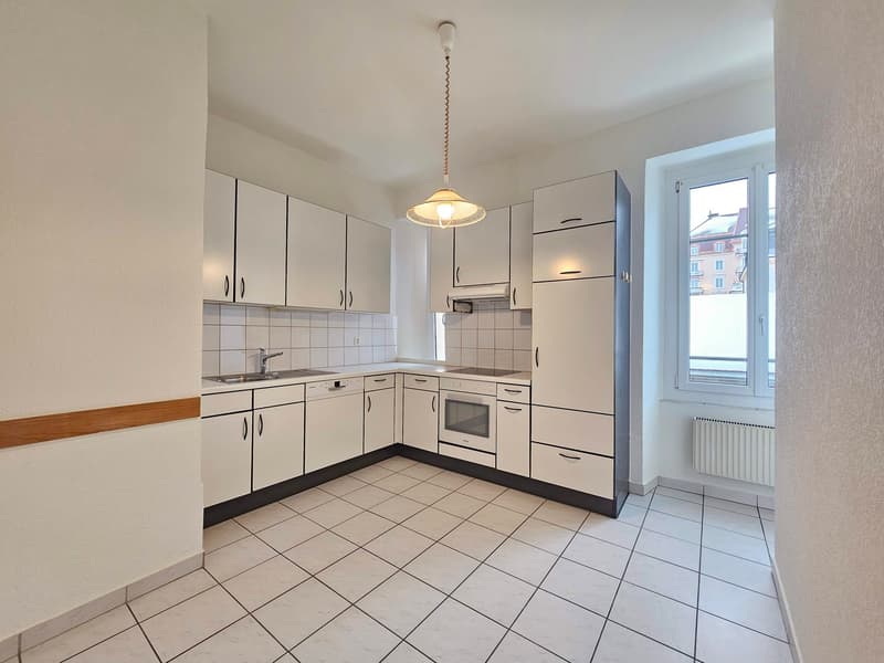 modern style kitchen, white cabinetry, white tile flooring, modern appliances, gas stove, white sink, modern faucet, built-in dishwasher