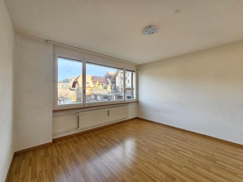 empty room, hardwood floor, large window, white walls, built-in radiator, large view