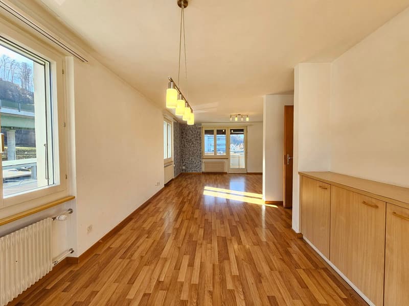 empty room, wooden floor, white walls, large window, balcony, radiator, wooden cabinets