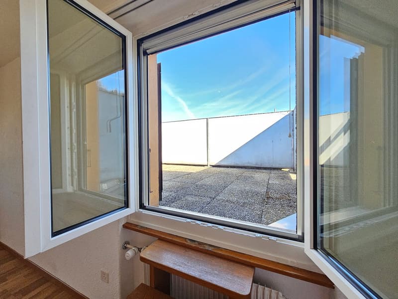 large window, wooden floor, white wall, balcony, radiator, power outlet