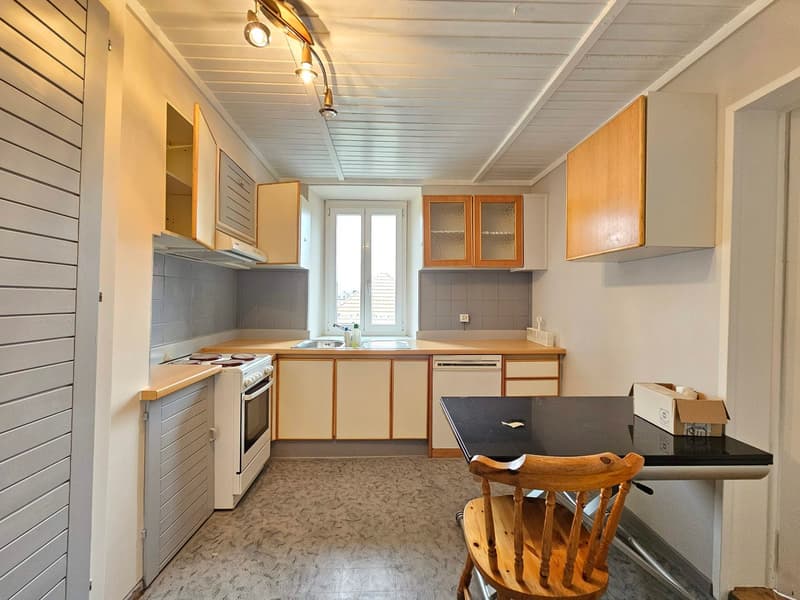 kitchen with built-in appliances, wooden cabinets, countertops, sink, dishwasher, refrigerator, and ceiling lamps