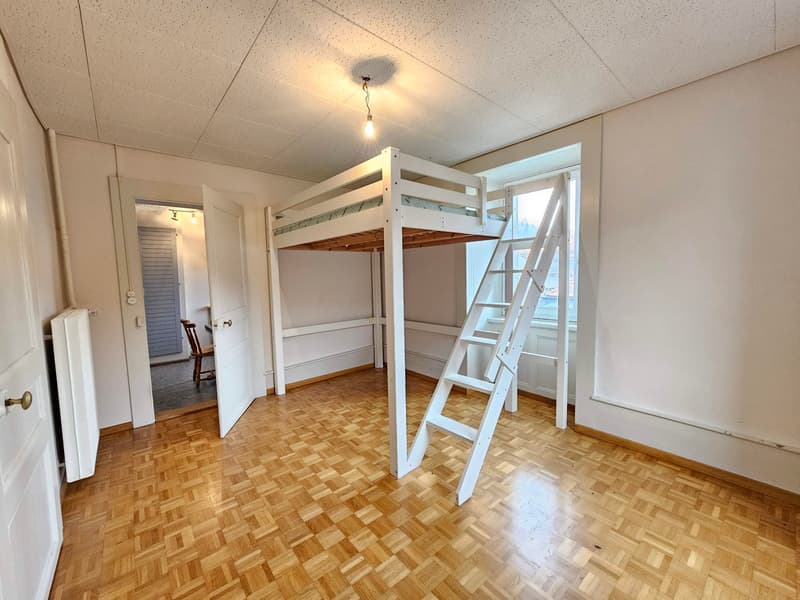 white bunk bed, white railing, white stairs, wooden floor, white walls, window, door, light
