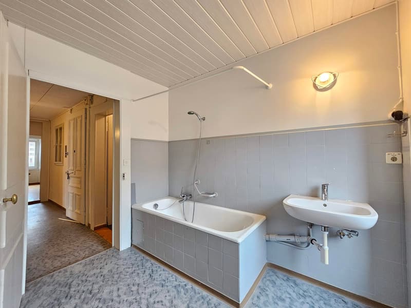 gray tiles, white bathtub, silver faucet, white sink, white wall, white ceiling