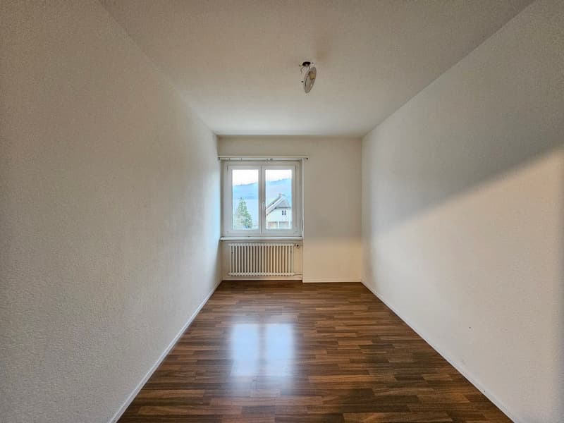 empty room, wooden floors, white walls, window, radiator