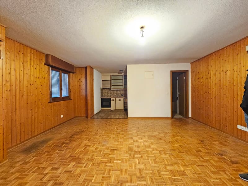 empty room, wooden floors, wooden walls, kitchen in the corner, windows