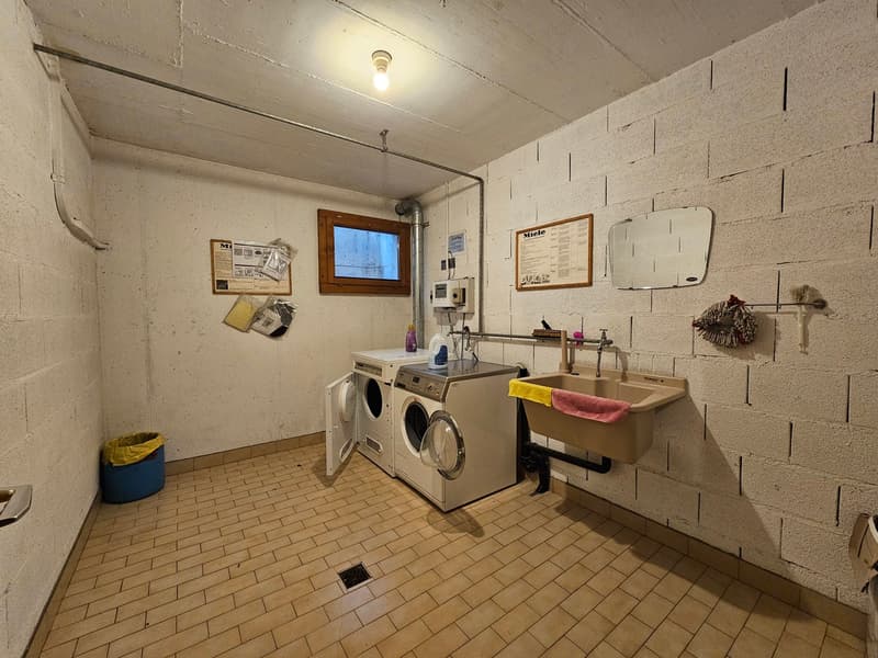 white tiled floor, washing machines, sink, small window, light