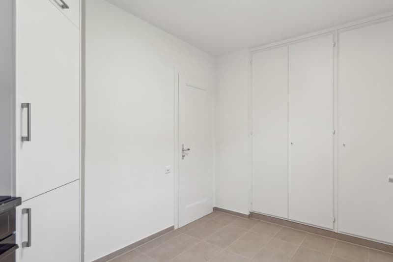 white walls, white flooring, white cupboards, white door