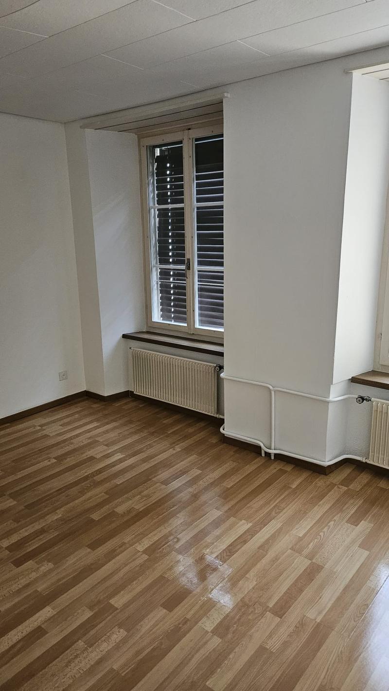 empty room, wooden floor, white walls, window, radiator, empty