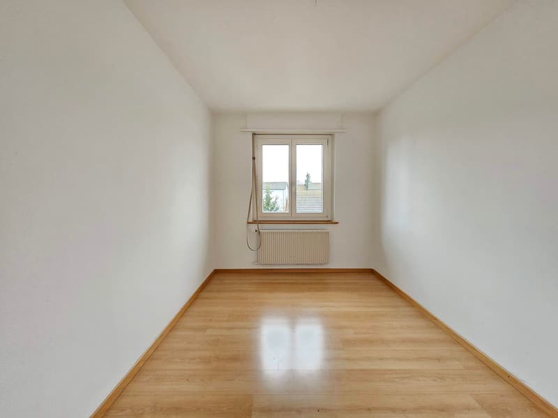 empty room, white walls, wooden floor, window, radiator