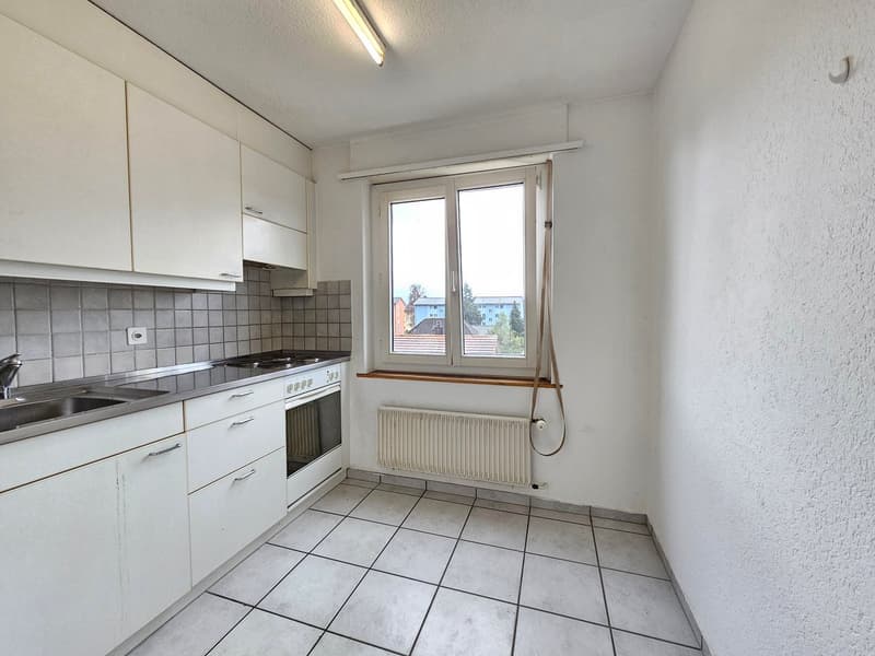 modern kitchen with white cabinets, tiled floor, stainless steel sink, electric stove, oven, window with view