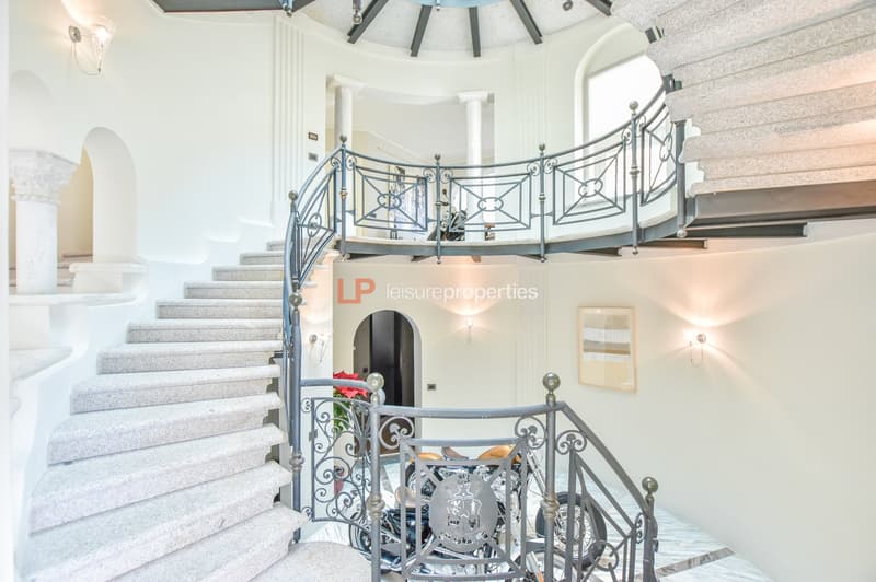white stairs with handrail, round window, round opening, motorcycle