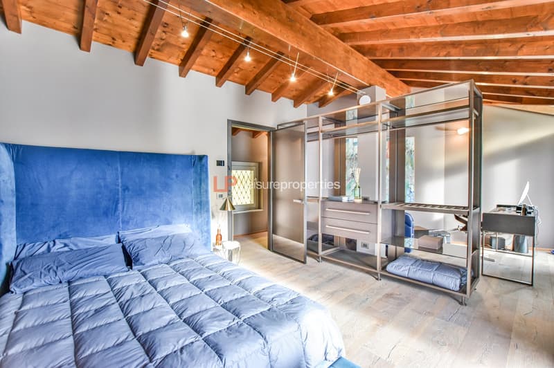 blue upholstered bed, wooden ceiling, shelves, large bed, wooden floor