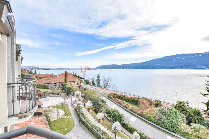 Lake Como view from a balcony, mountain range, green trees, pathway, water body, building