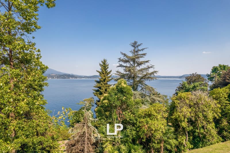 lakefront property, surrounded by trees and greenery, panoramic view of the lake and mountains