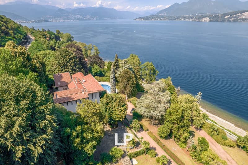 Large house on hillside, red roof, pool, wide garden, coastal view