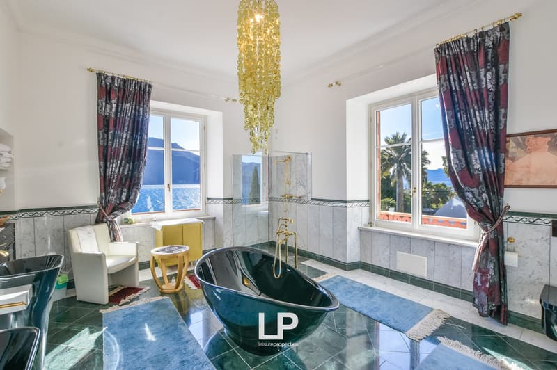 marble tiled, large bathtub, gold faucets, chandelier, large windows, ocean view